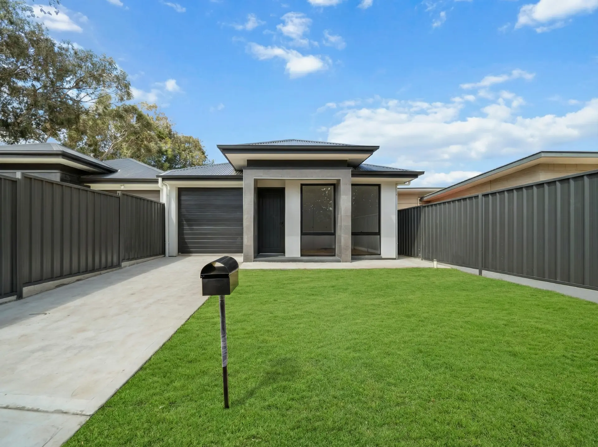 Single storey Paralowie home facade with stone entry portico and lawn