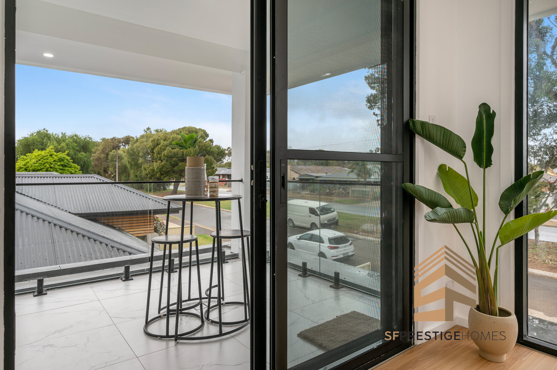 Upper level balcony of a double storey SF Prestige home with glass balustrade